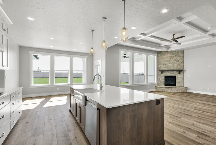 Greyloch Open Concept Kitchen Cabinetry open concept kitchen with white cabinets and stone fireplace