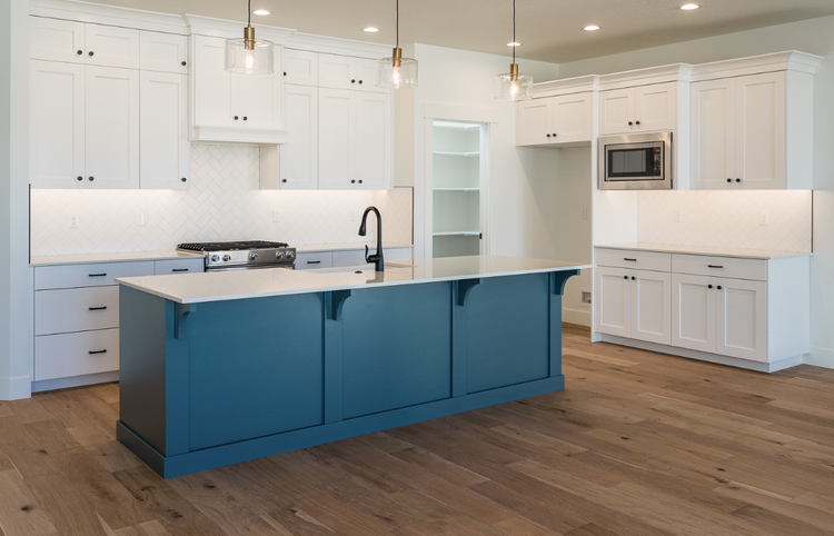 Greyloch Two-Tone Kitchen with Teal Island White kitchen cabinets with teal island and pendant lighting