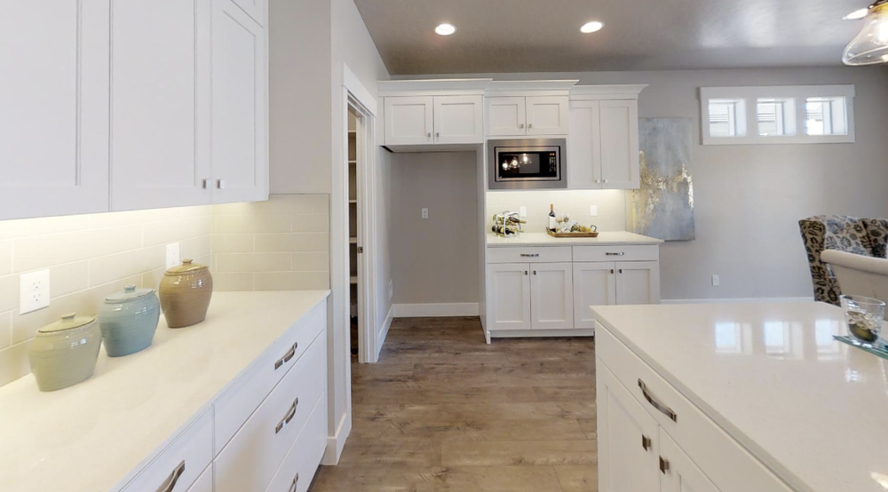 Greyloch White Kitchen Cabinet Installation white kitchen cabinets with built-in microwave and wood floors