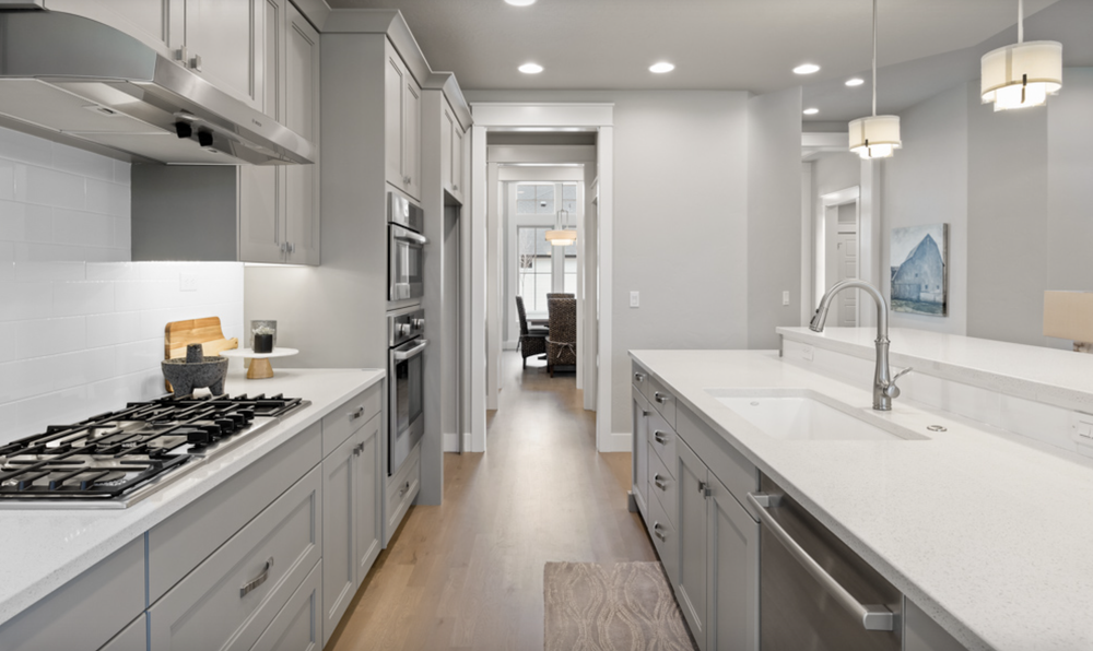 Greyloch Gray Kitchen Cabinetry with Gas Range gray kitchen cabinets with quartz countertops and gas range