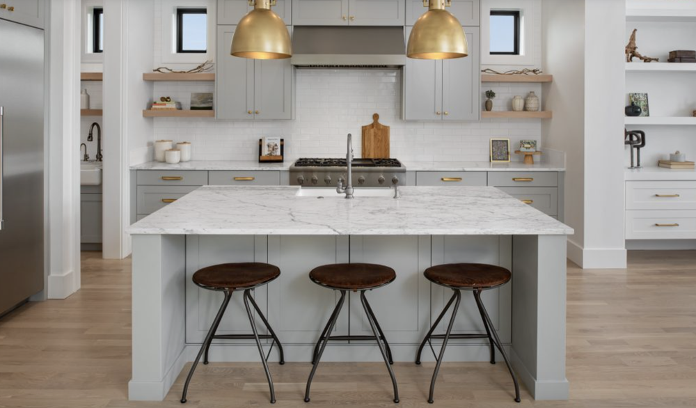 Greyloch Kitchen Island with Gold Pendant Lighting gray kitchen island with marble countertop and gold pendants