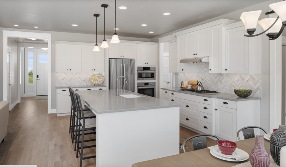 Greyloch White Kitchen with Herringbone Backsplash white kitchen cabinets with stainless appliances and herringbone backsplash