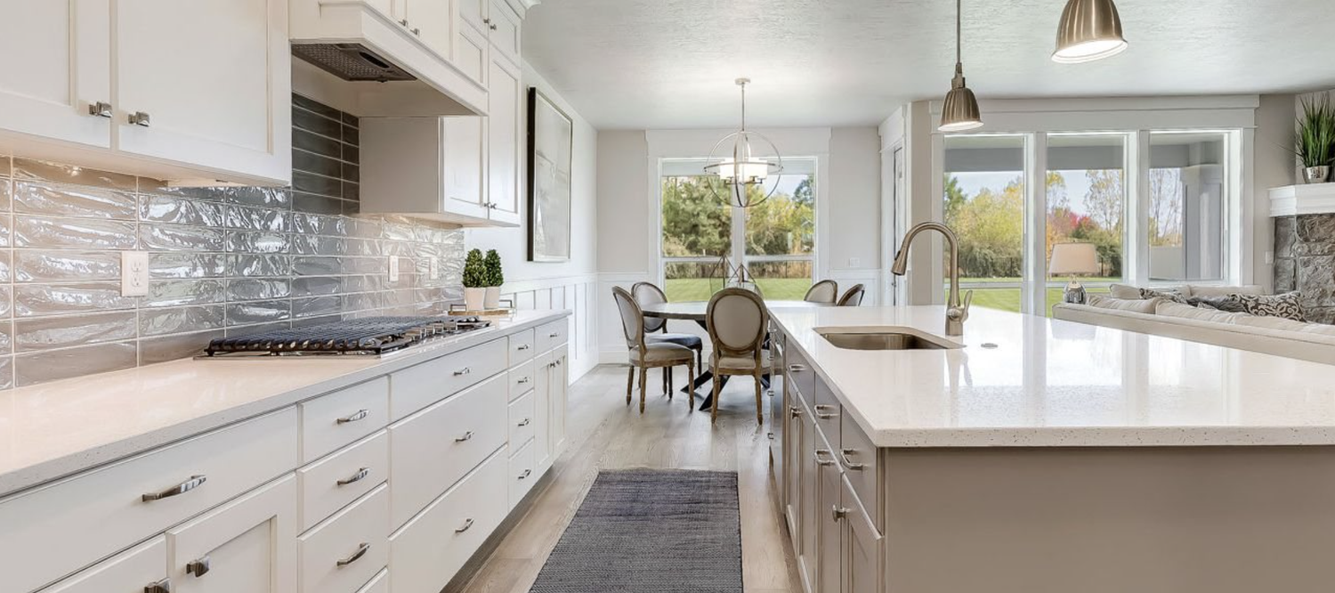 Greyloch White Kitchen Island with Pendants white kitchen with large island and pendant lighting