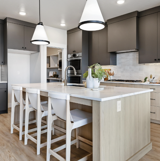 Greyloch Two-Tone Gray and White Kitchen gray kitchen cabinets with white island and pendant lighting