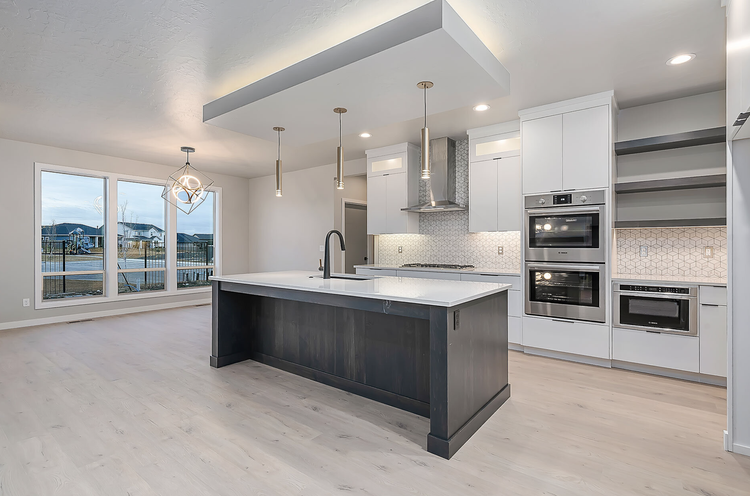 Greyloch White Kitchen with Dark Island and Wall Ovens white kitchen with dark island and double wall ovens