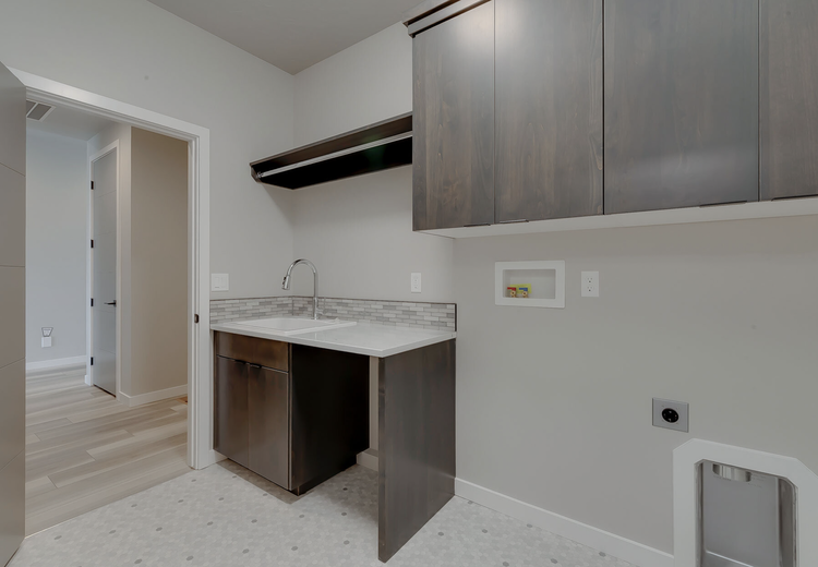 Greyloch Gray Tall Cabinet Installation gray tall cabinets with quartz countertop and wood accents