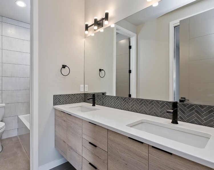Greyloch Bathroom Vanity with Herringbone Tile white bathroom vanity with herringbone tile and black sconces