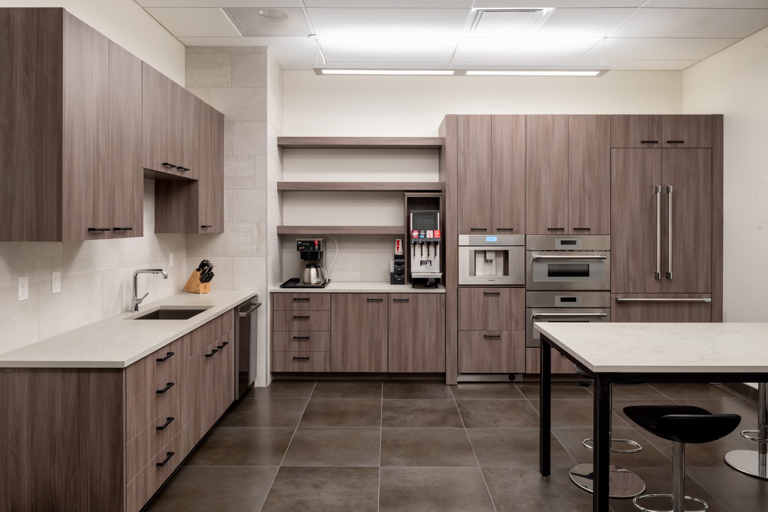 commercial breakroom with wood cabinets and mini fridge